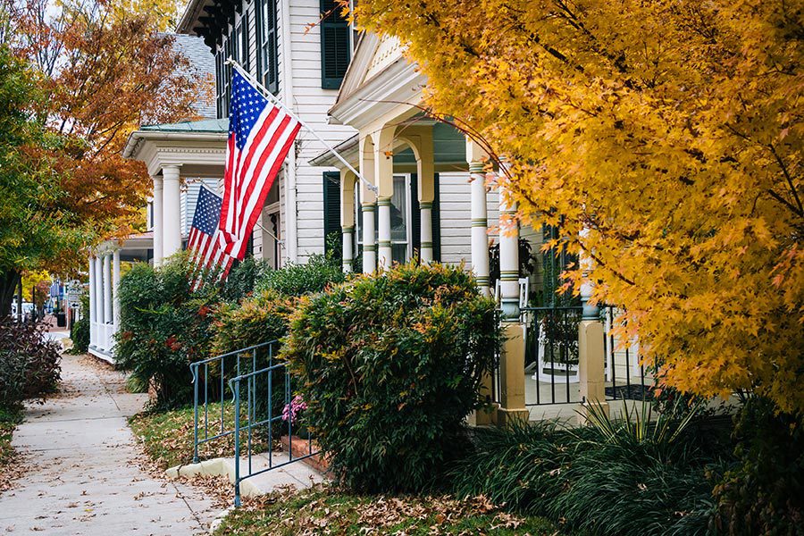 Corinth, MS Insurance - Beautiful Small Town Street With Fall Leaves, American Flags and Cozy Front Porches